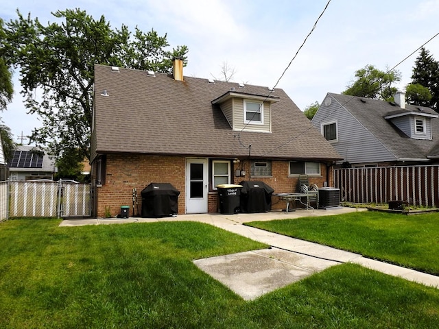 17008 Oakwood Ave, Lansing, IL 60438 - back of property with brick siding, a patio, a chimney, and a shingled roof