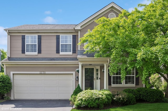 2570 Fairfax Ln, Lake In The Hills, IL 60156 - view of front facade with an attached garage and asphalt driveway