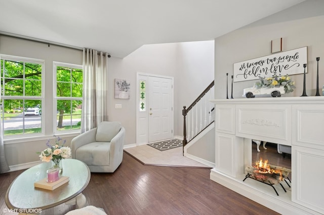 2570 Fairfax Ln, Lake In The Hills, IL 60156 - living area featuring dark wood-type flooring, stairs, and vaulted ceiling