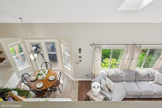 2570 Fairfax Ln, Lake In The Hills, IL 60156 - living area with wood finished floors, healthy amount of natural light, and a skylight