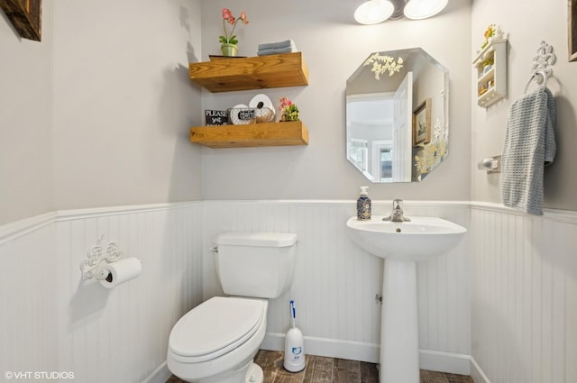 2570 Fairfax Ln, Lake In The Hills, IL 60156 - half bathroom featuring a wainscoted wall and wood finished floors