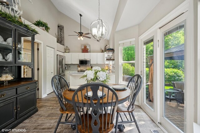 2570 Fairfax Ln, Lake In The Hills, IL 60156 - dining area with lofted ceiling, a chandelier, ceiling fan, and dark wood finished floors