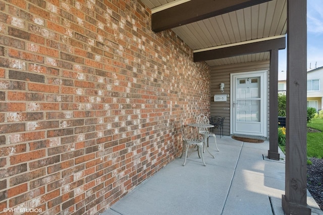 1351 Kingsbury Dr Unit 5, Hanover Park, IL 60133 - doorway to property featuring brick siding and covered porch