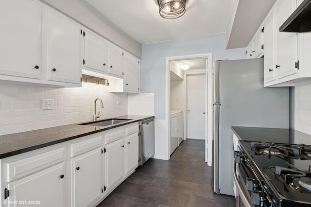 1351 Kingsbury Dr Unit 5, Hanover Park, IL 60133 - kitchen featuring separate washer and dryer, wall chimney exhaust hood, white cabinets, tasteful backsplash, and gas stove