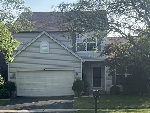 142 Sedgewicke Dr, Romeoville, IL 60446 - traditional home featuring asphalt driveway, a front yard, and roof with shingles