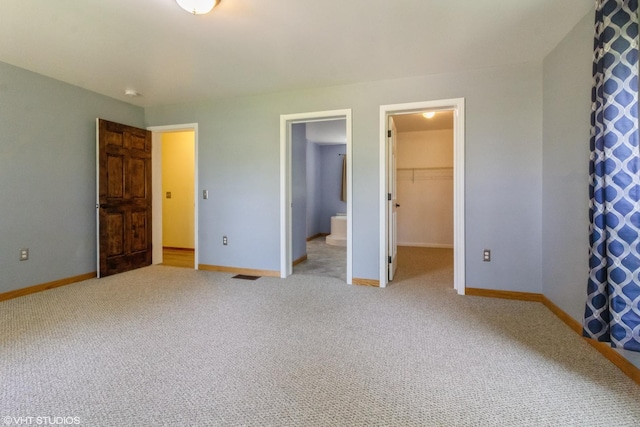 32597 Genoa Rd, Genoa, IL 60135 - unfurnished bedroom with a spacious closet, carpet floors, a closet, and connected bathroom