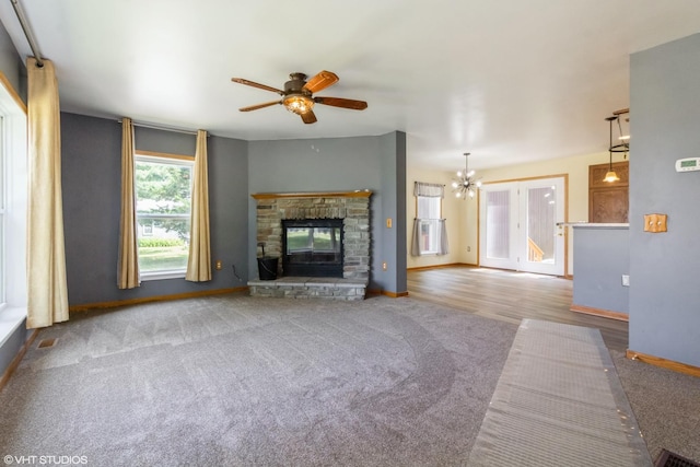 32597 Genoa Rd, Genoa, IL 60135 - unfurnished living room featuring carpet, a ceiling fan, and a stone fireplace