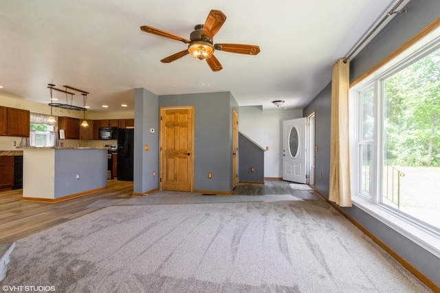 32597 Genoa Rd, Genoa, IL 60135 - unfurnished living room featuring ceiling fan, light carpet, light wood finished floors, and recessed lighting