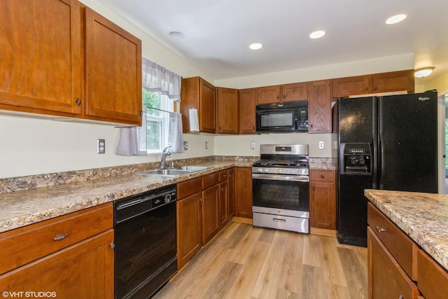 32597 Genoa Rd, Genoa, IL 60135 - kitchen with black appliances, light wood-style floors, brown cabinetry, and recessed lighting