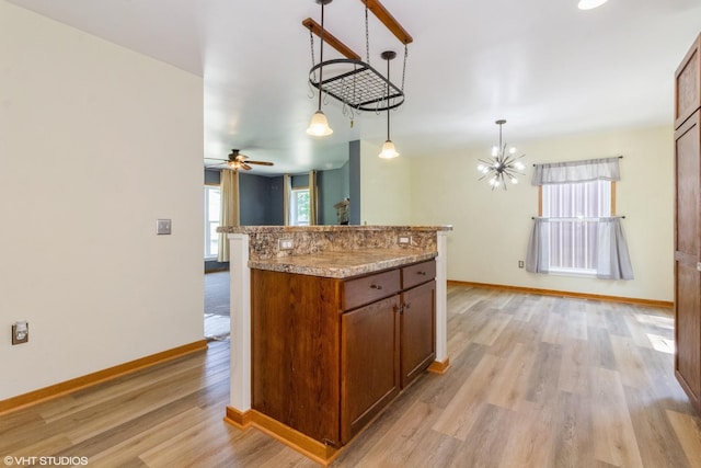 32597 Genoa Rd, Genoa, IL 60135 - kitchen with light wood-style floors, a chandelier, brown cabinetry, and decorative light fixtures