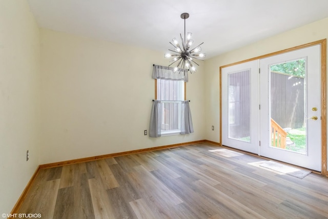 32597 Genoa Rd, Genoa, IL 60135 - spare room featuring a chandelier and wood finished floors