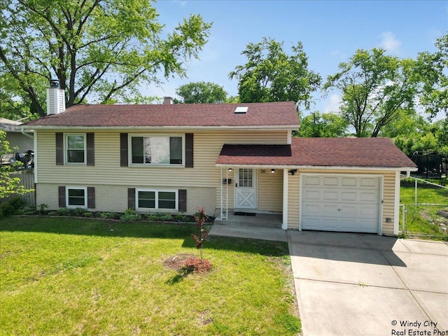 36 W Green Meadows Blvd, Streamwood, IL 60107 - split level home featuring an attached garage, concrete driveway, and a chimney