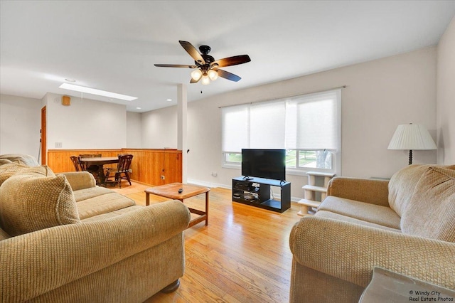 36 W Green Meadows Blvd, Streamwood, IL 60107 - living room with a ceiling fan, light wood finished floors, and wainscoting