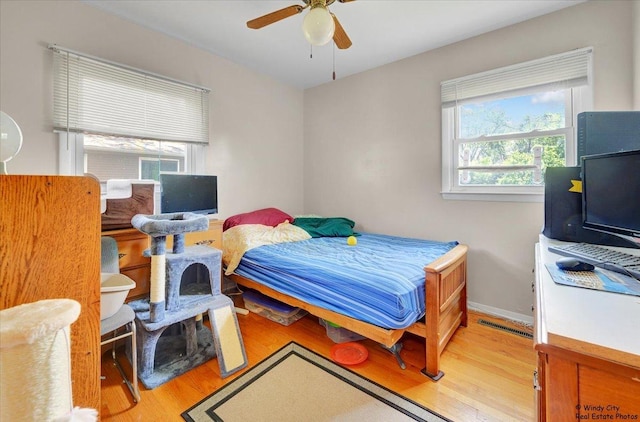 36 W Green Meadows Blvd, Streamwood, IL 60107 - bedroom featuring multiple windows, light wood-type flooring, and a ceiling fan