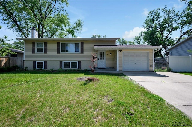 36 W Green Meadows Blvd, Streamwood, IL 60107 - tri-level home with concrete driveway, an attached garage, and a chimney