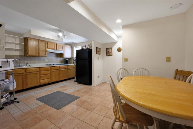 36 W Green Meadows Blvd, Streamwood, IL 60107 - kitchen with freestanding refrigerator, open shelves, light countertops, backsplash, and white microwave