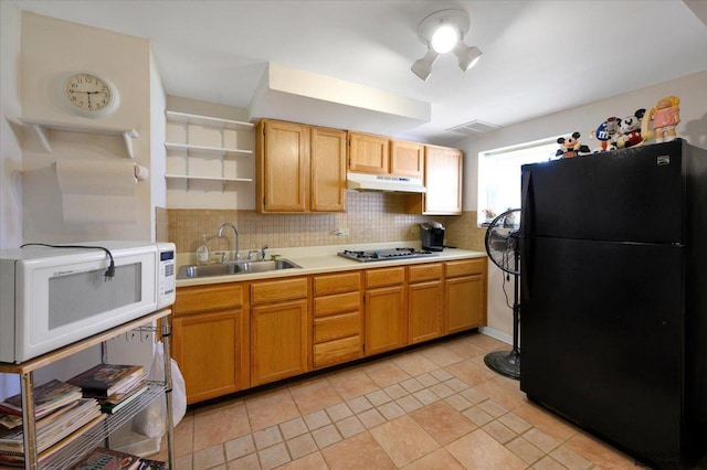 36 W Green Meadows Blvd, Streamwood, IL 60107 - kitchen with freestanding refrigerator, white microwave, under cabinet range hood, open shelves, and tasteful backsplash