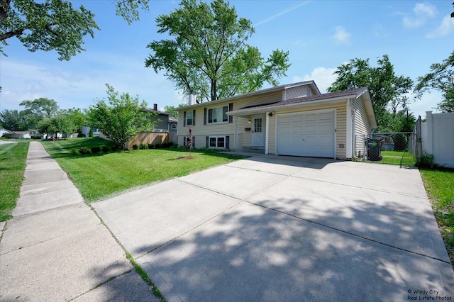 36 W Green Meadows Blvd, Streamwood, IL 60107 - tri-level home featuring an attached garage, driveway, and a gate