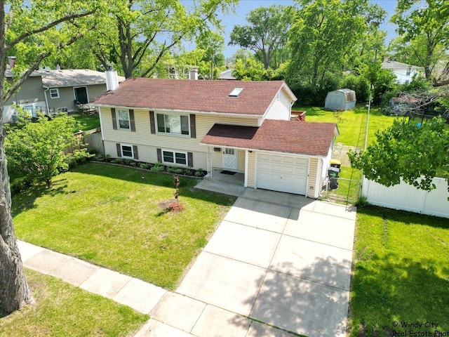 36 W Green Meadows Blvd, Streamwood, IL 60107 - view of front of house with concrete driveway, a garage, a chimney, and a storage unit