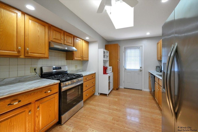 36 W Green Meadows Blvd, Streamwood, IL 60107 - kitchen featuring appliances with stainless steel finishes, under cabinet range hood, ceiling fan, light countertops, and brown cabinetry