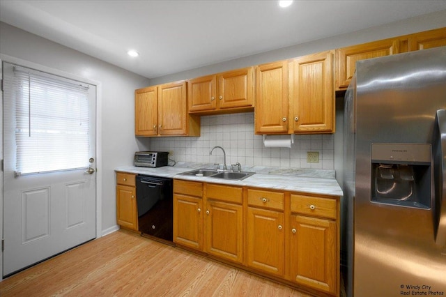 36 W Green Meadows Blvd, Streamwood, IL 60107 - kitchen with stainless steel fridge with ice dispenser, black dishwasher, light countertops, backsplash, and light wood-type flooring