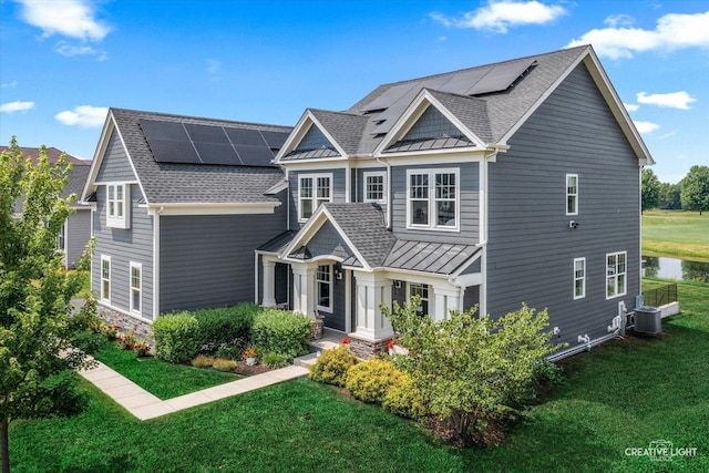 3578 Doral Dr, Elgin, IL 60124 - view of front of property featuring a standing seam roof, a front yard, solar panels, and a metal roof