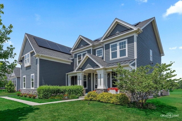 3578 Doral Dr, Elgin, IL 60124 - craftsman-style house featuring solar panels, a front lawn, and a shingled roof