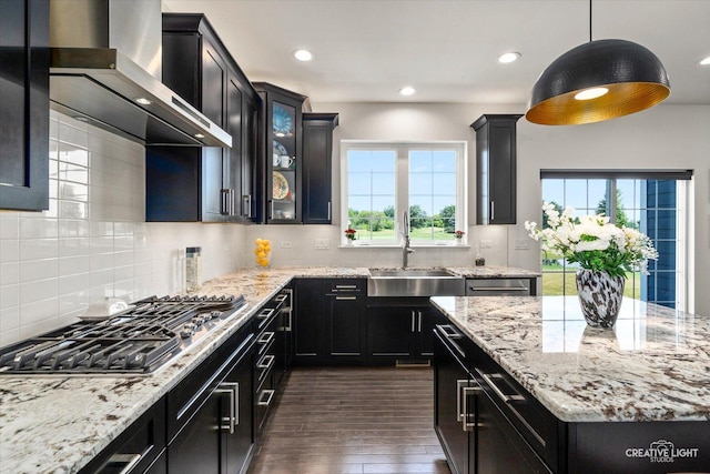 3578 Doral Dr, Elgin, IL 60124 - kitchen featuring stainless steel gas stovetop, wall chimney range hood, dark cabinetry, dark wood-type flooring, and recessed lighting