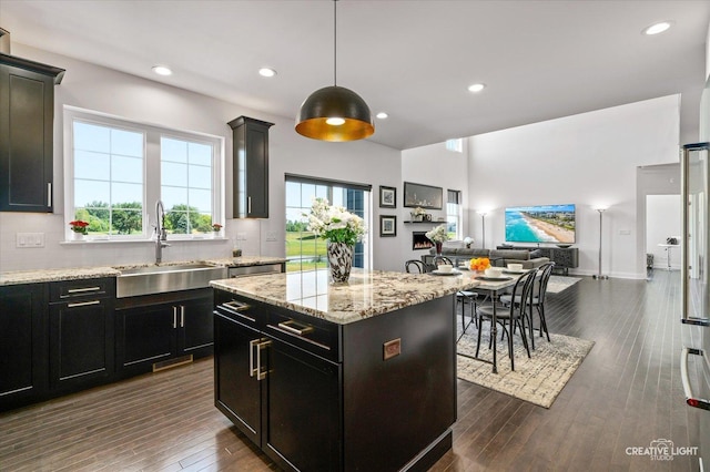 3578 Doral Dr, Elgin, IL 60124 - kitchen with open floor plan, decorative backsplash, light stone countertops, dark wood-style floors, and a center island