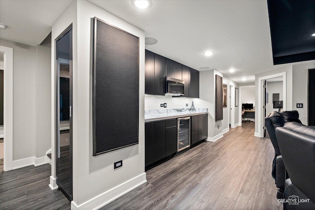 3578 Doral Dr, Elgin, IL 60124 - kitchen with dark cabinetry, wine cooler, light countertops, wood finished floors, and recessed lighting