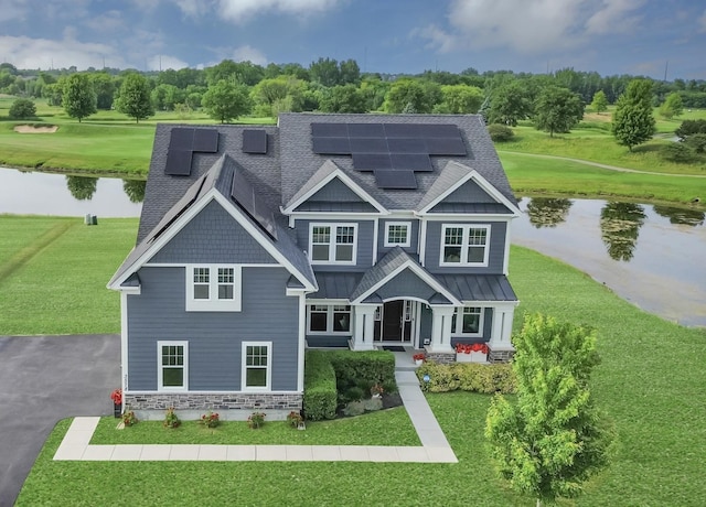 3578 Doral Dr, Elgin, IL 60124 - view of front of property featuring a water view, a standing seam roof, a shingled roof, and a front yard