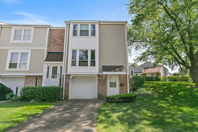 2165 Greystone Pl, Hoffman Estates, IL 60169 - view of front of property featuring brick siding, an attached garage, asphalt driveway, and a front yard