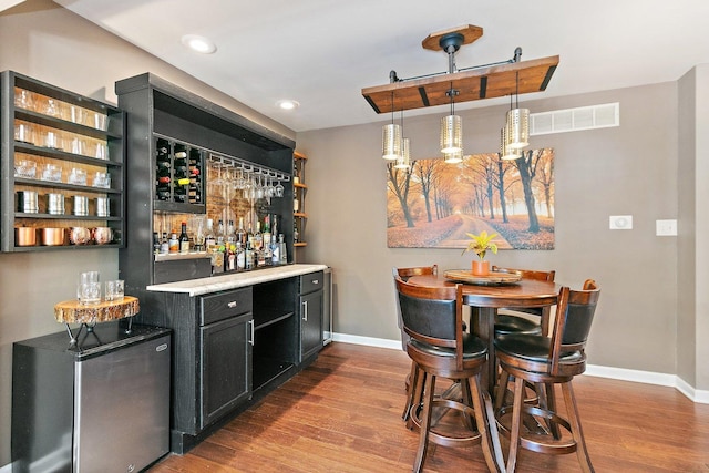 2165 Greystone Pl, Hoffman Estates, IL 60169 - indoor dry bar featuring wood finished floors, refrigerator, decorative light fixtures, and recessed lighting