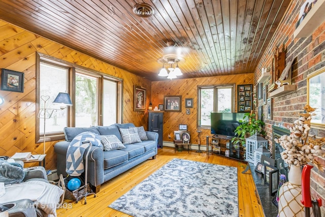 14119 W Maple Rd, Mokena, IL 60448 - living room with healthy amount of natural light, wood ceiling, wooden walls, a baseboard radiator, and a brick fireplace