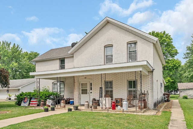 107 N Elm St, Gardner, IL 60424 - view of front of property with a front yard, brick siding, and stucco siding