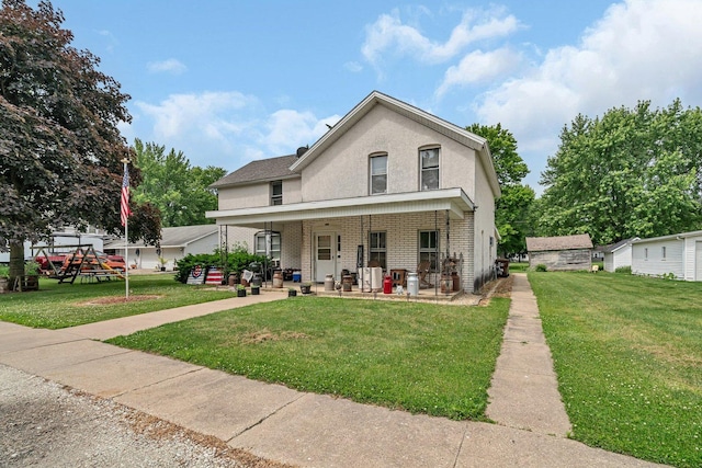 107 N Elm St, Gardner, IL 60424 - view of front facade with a front lawn, stucco siding, brick siding, and covered porch