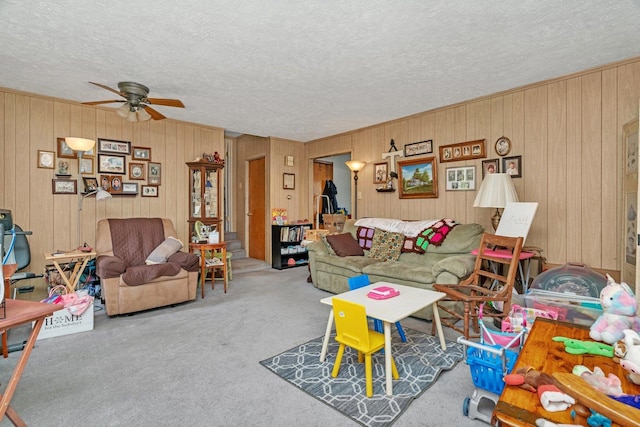 107 N Elm St, Gardner, IL 60424 - living area with ceiling fan, a textured ceiling, carpet floors, and wooden walls