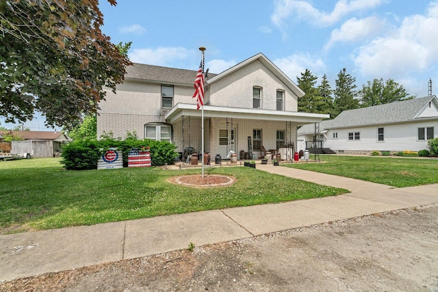 107 N Elm St, Gardner, IL 60424 - view of front of home featuring covered porch, a front yard, stucco siding, and brick siding