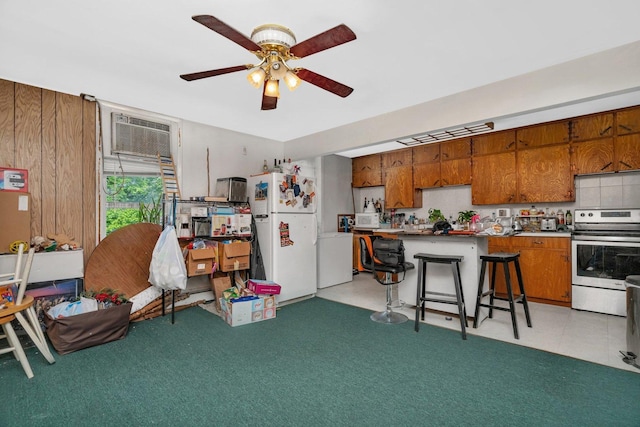 107 N Elm St, Gardner, IL 60424 - kitchen with electric range, freestanding refrigerator, brown cabinetry, ceiling fan, and backsplash