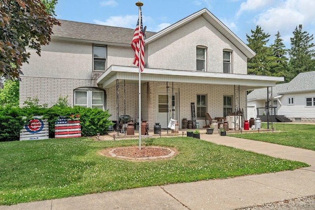 107 N Elm St, Gardner, IL 60424 - view of front of property with a front lawn, stucco siding, covered porch, and brick siding