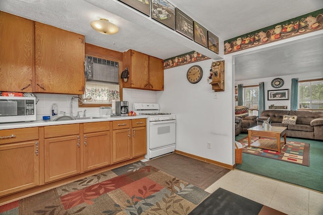 107 N Elm St, Gardner, IL 60424 - kitchen featuring white appliances, light countertops, backsplash, and open floor plan