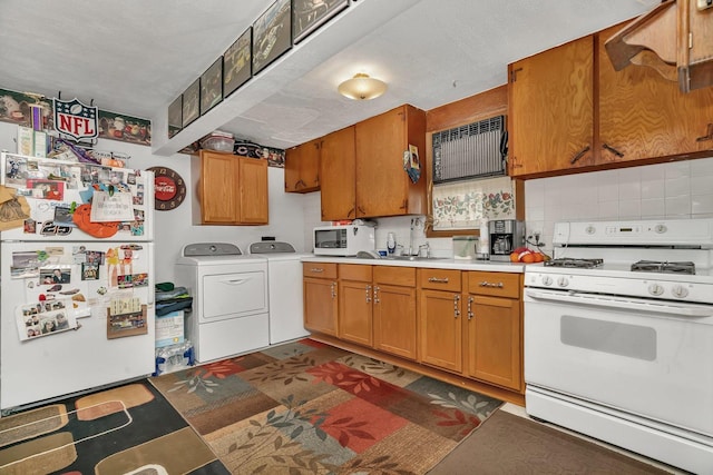 107 N Elm St, Gardner, IL 60424 - kitchen with white appliances, independent washer and dryer, light countertops, backsplash, and brown cabinets