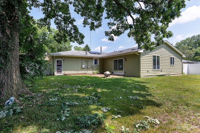 306 Hillside Pl, North Aurora, IL 60542 - rear view of house featuring roof mounted solar panels, a lawn, and a patio area