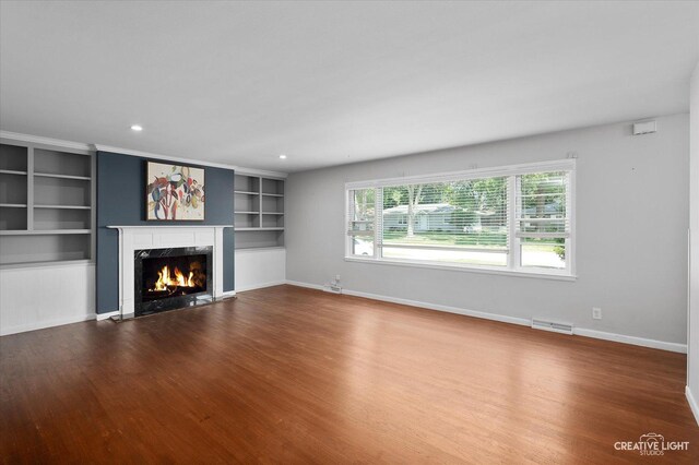 306 Hillside Pl, North Aurora, IL 60542 - unfurnished living room featuring a fireplace, wood finished floors, built in features, and recessed lighting