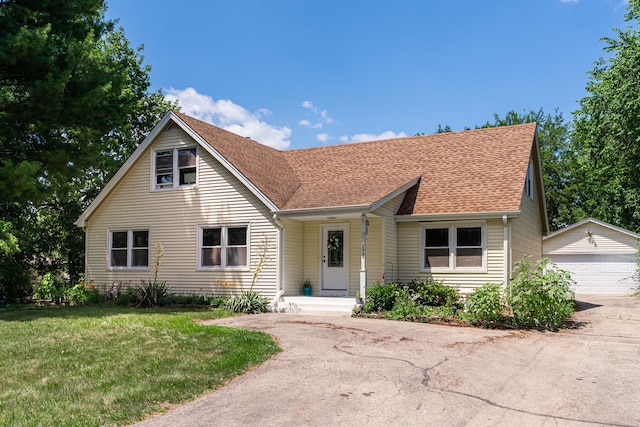 2040 Poplar Ave, Hanover Park, IL 60133 - view of front of property featuring an outdoor structure, a detached garage, a front yard, and roof with shingles