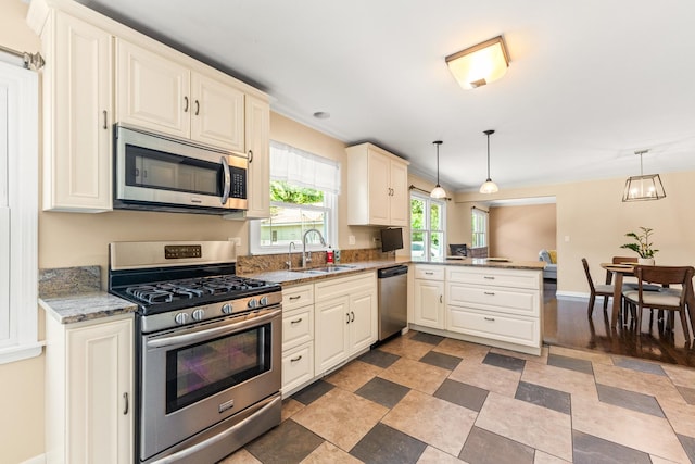 2040 Poplar Ave, Hanover Park, IL 60133 - kitchen with stainless steel appliances, a peninsula, ornamental molding, hanging light fixtures, and light stone countertops
