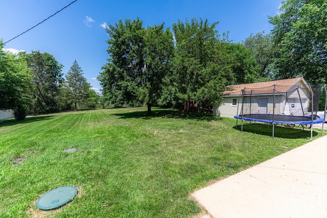 2040 Poplar Ave, Hanover Park, IL 60133 - view of grassy yard featuring a trampoline