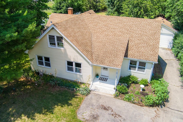 2040 Poplar Ave, Hanover Park, IL 60133 - view of front of property with roof with shingles, a chimney, covered porch, and an outbuilding
