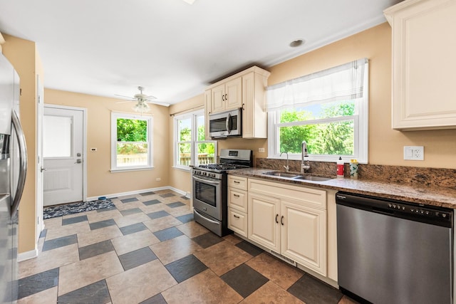 2040 Poplar Ave, Hanover Park, IL 60133 - kitchen featuring appliances with stainless steel finishes, ceiling fan, cream cabinets, and stone counters