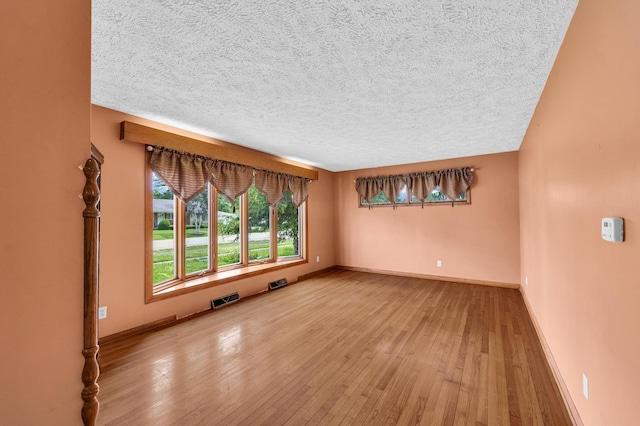 319 N Third St, Fisher, IL 61843 - spare room with hardwood / wood-style flooring and a textured ceiling
